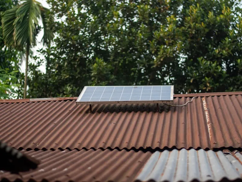 Installateur RGE QualiPV pose un panneau solaire sur un toit à Occitanie